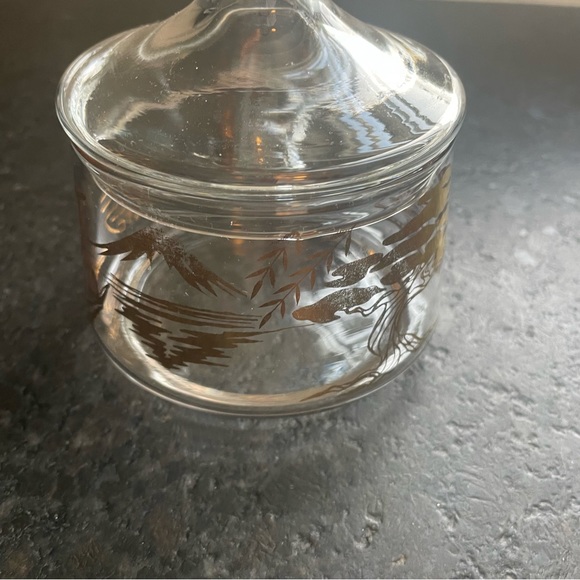 Round clear glass trinket jar with a lid, adorned with gold Asian symbols - Picture 3 of 9